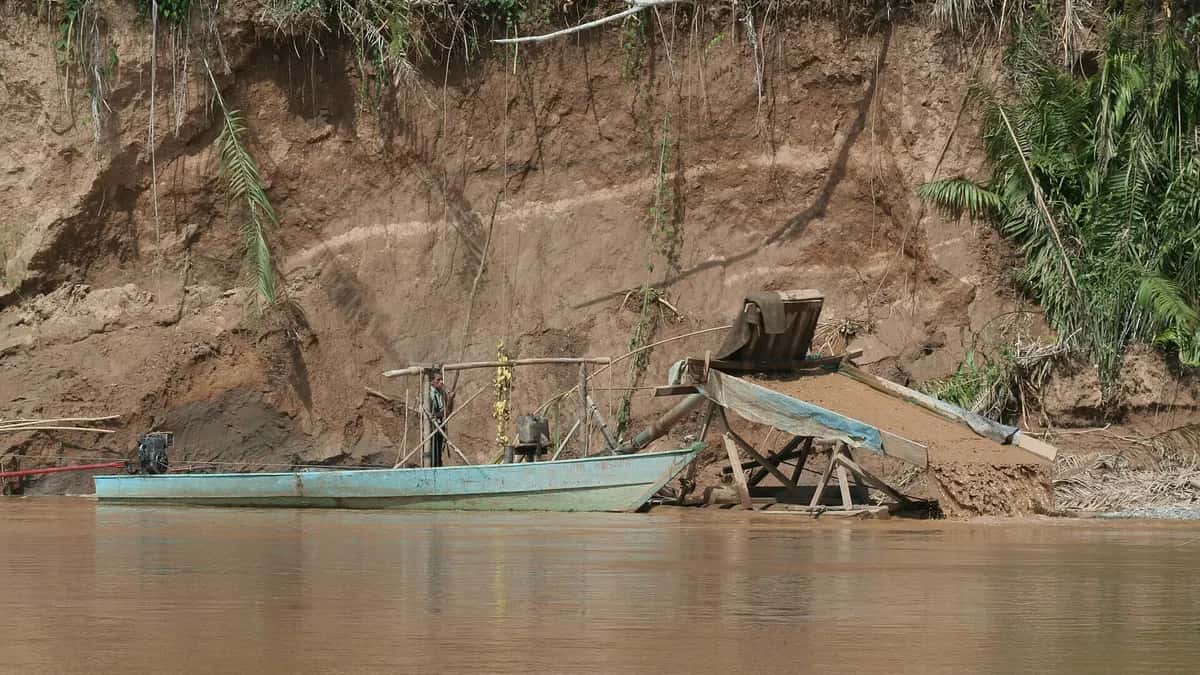 Gold suction dredge on the bank of the Madre de Dios River in Peru