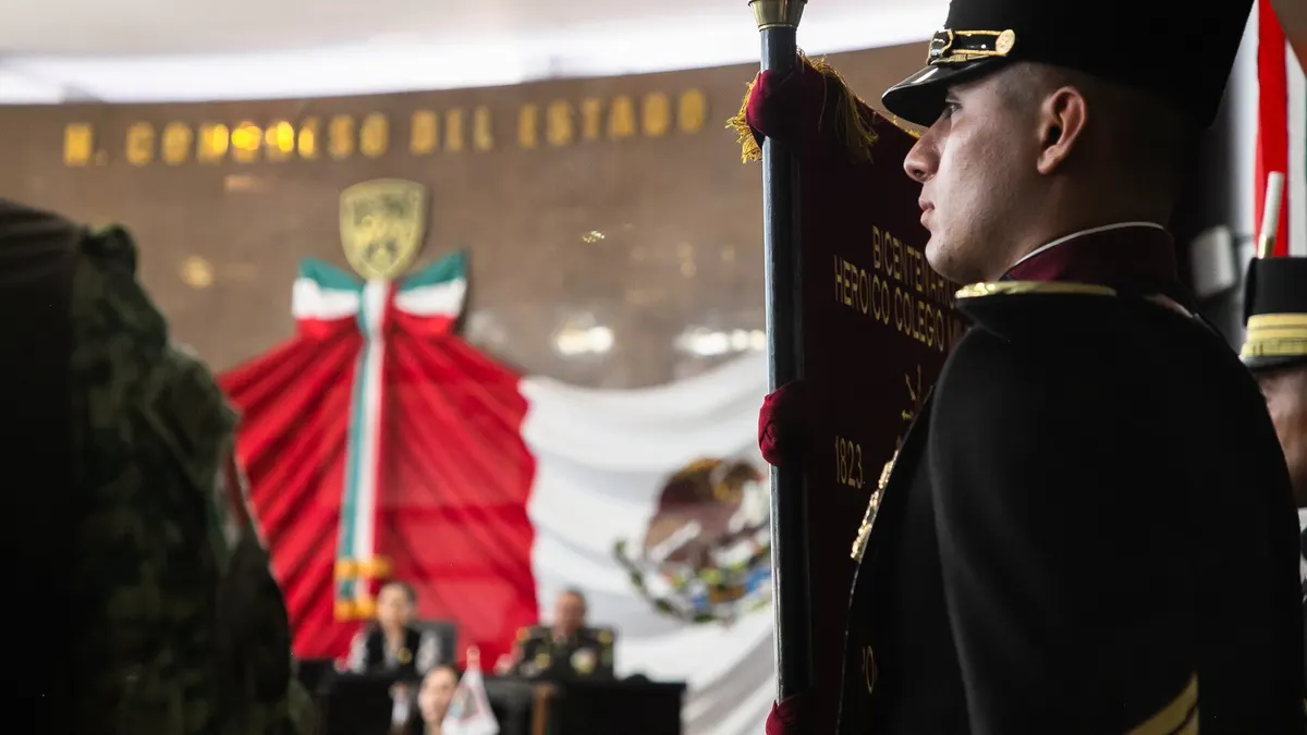 Heroic Military College cadet with the Mexican flag at an official ceremony