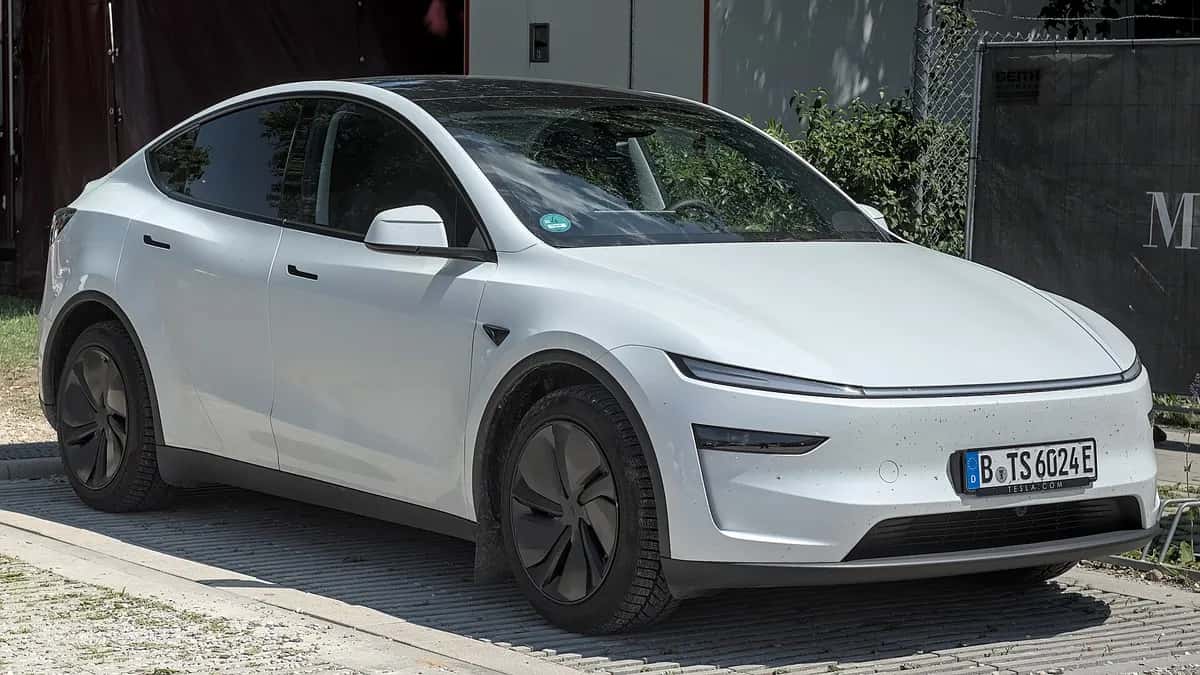 White 2025 Tesla Model Y parked on a street
